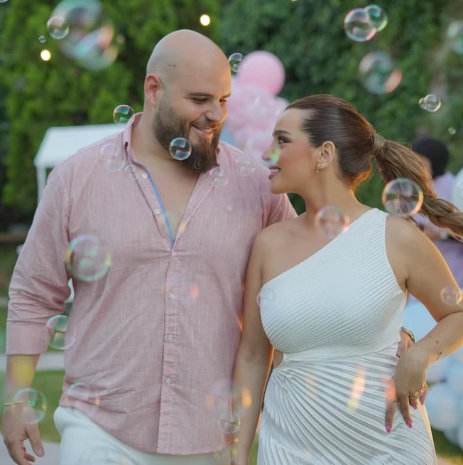 A couple sharing a moment among bubbles and pastel balloons