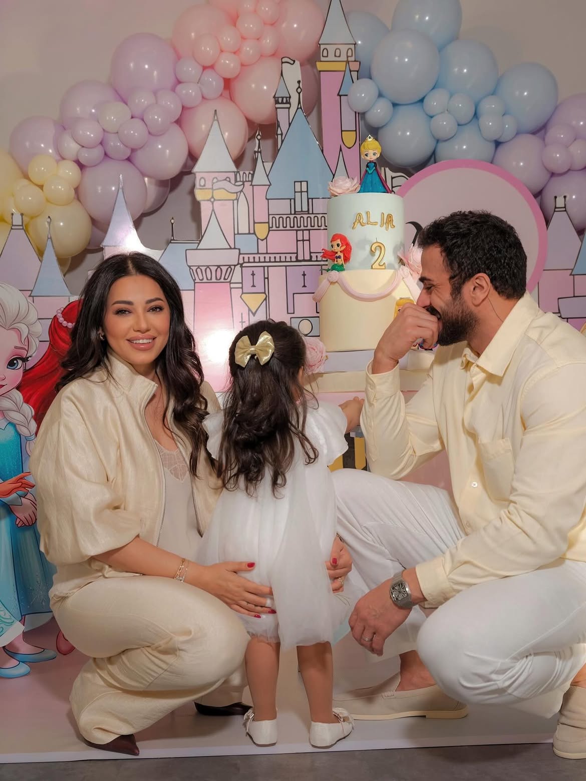 A family celebration with a pastel castle and birthday cake
