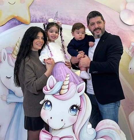 A family together at a pastel unicorn celebration