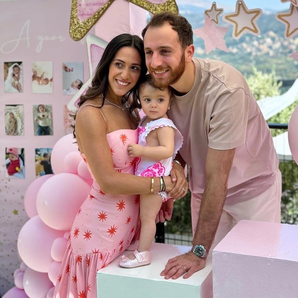 A family celebrating together with pink party decorations