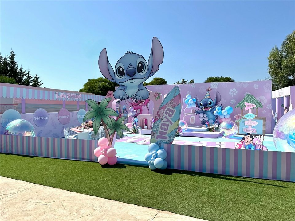 Pastel Stitch party with tropical palms and flower balloons